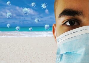 Es ist ein Stand vor blauem Himmel zu sehen. Im Vordergrund ist ein Mann mit Mund-Nasen Schutz zu sehen. Viren Icons fliegen in der Luft.