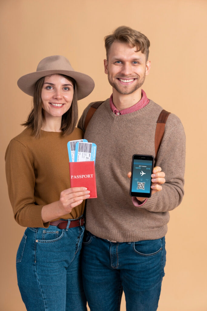 young-couple-holding-smartphone-plane-tickets-traveling(1)