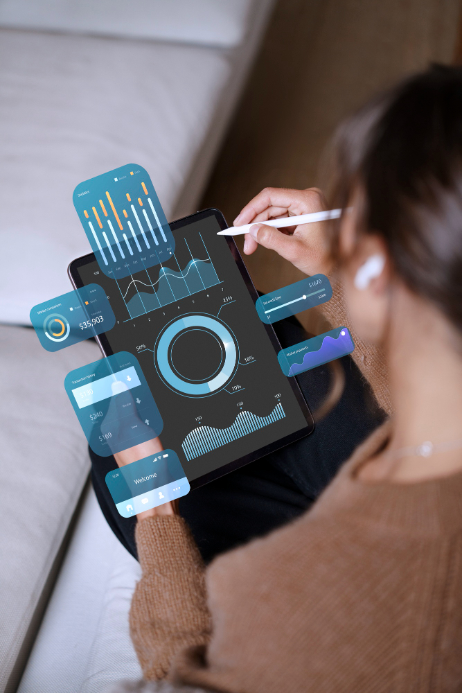 Frau vor Handy mit Grafiken und technischen Tabellen.